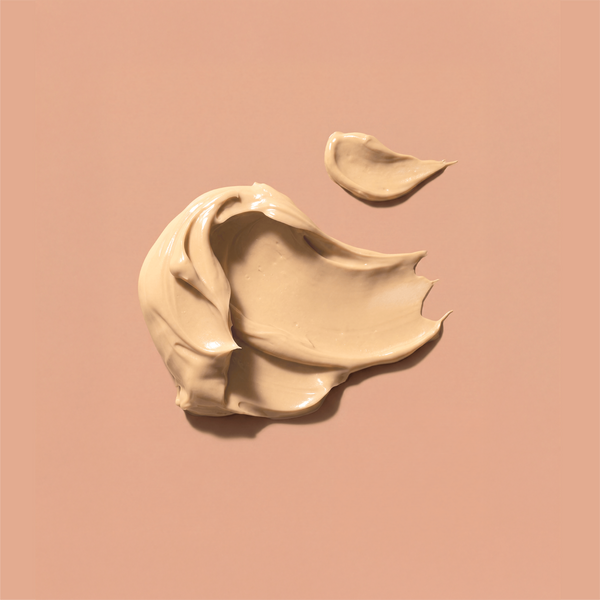 Swatches of frank body Firm + Glow Tan Butter on a tan background.