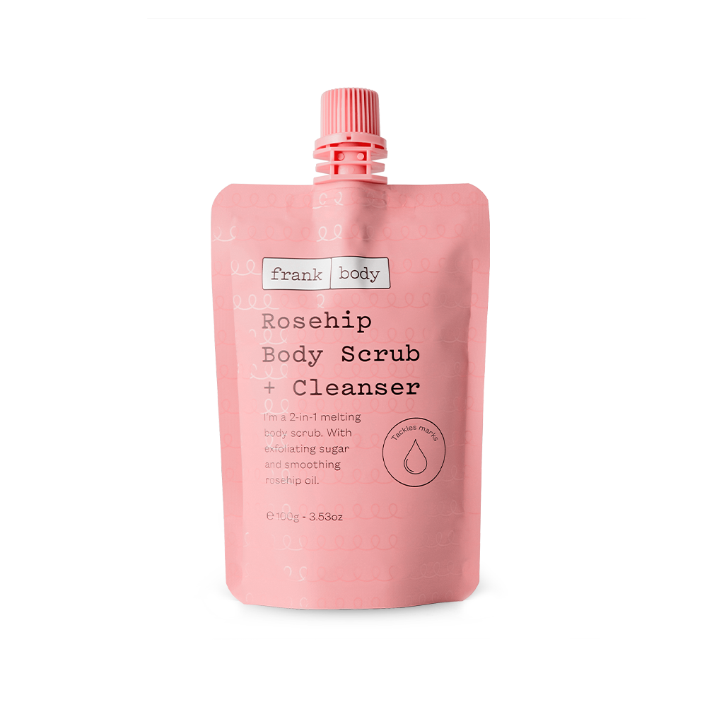 A pink squeeze pouch of frank body Rosehip Body Scrub + Cleanser with a pink flip-top cap, shown on a clean white background.