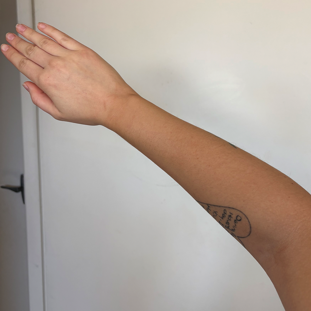 After using frank body Firm + Glow Tan Butter: a bronzed, evenly tanned forearm.