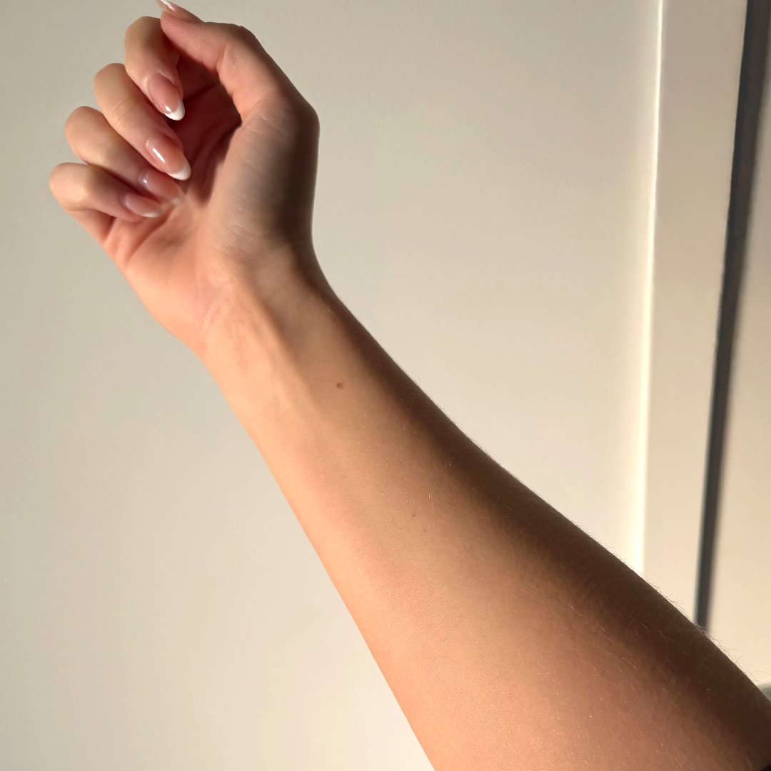 After using frank body Firm + Glow Self Tan Mousse: a bronzed, evenly tanned forearm.