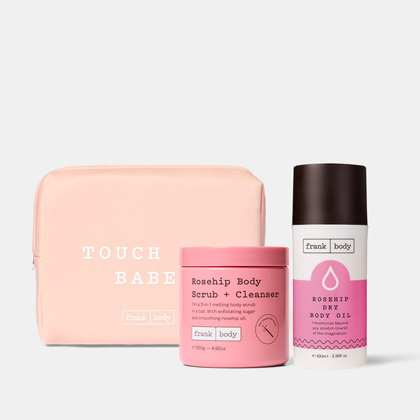The frank body Grab My Rosehips Kit: Rosehip Body Scrub + Cleanser and Rosehip Dry Body Oil with a pink Touch Me Babe pouch.