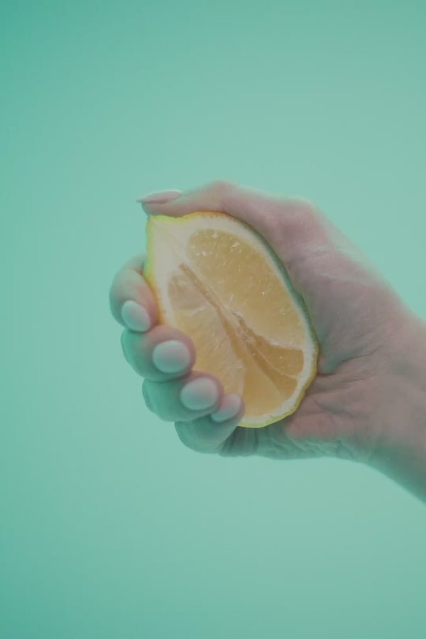 frank body Main Squeeze gift set video: a silver dome is lifted to reveal the kit, and a model applies body lotion against a mint backdrop.