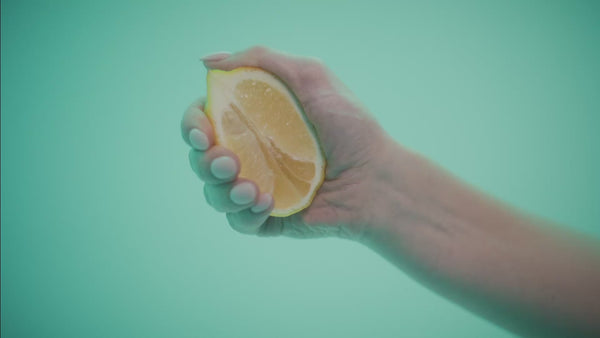 frank body Main Squeeze gift set video: a silver dome is lifted to reveal the kit, and a model applies body lotion against a mint backdrop.